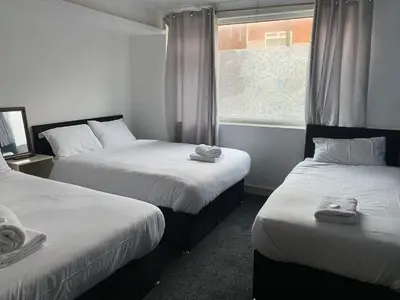 a room with two beds and a window at The Regency Hotel in Blackpool