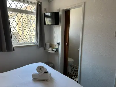 a room with a bed with a towel and a window at The Regency Hotel in Blackpool