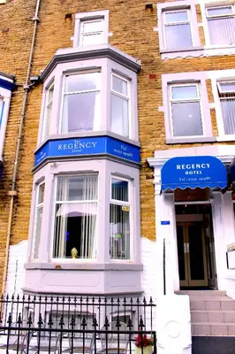 a building with blue signs on the front of it at The Regency Hotel in Blackpool