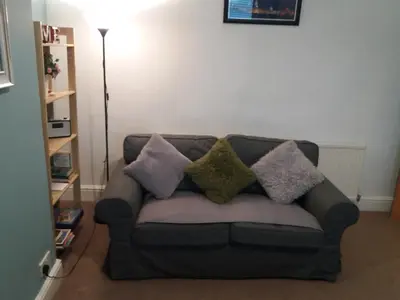 a couch with pillows on it in a living room at Mersey View, Two Bedroom Apartment, Liverpool in Waterloo