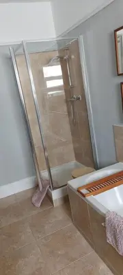 a shower with a glass door in a bathroom at Mersey View, Two Bedroom Apartment, Liverpool in Waterloo