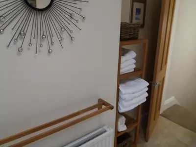 a bathroom with a mirror and a closet with towels at Mersey View, Two Bedroom Apartment, Liverpool in Waterloo
