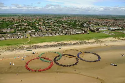 a group of people forming the olympic rings on a beach at Mersey View, Two Bedroom Apartment, Liverpool in Waterloo