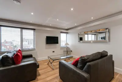a living room with two couches and a tv at The Picture House Apartments in Liverpool