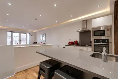 a large kitchen with a counter and a counter top at The Picture House Apartments in Liverpool
