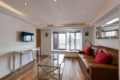 a living room with a couch and a table at The Picture House Apartments in Liverpool