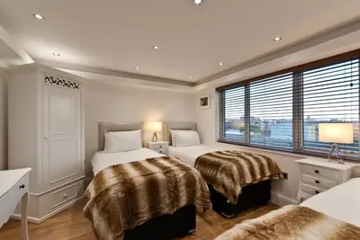 a bedroom with two beds and a window at The Picture House Apartments in Liverpool
