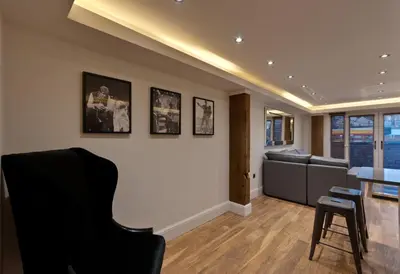 a living room with a black chair and a table at The Picture House Apartments in Liverpool