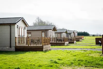 a row of houses in a field of grass at Ream Hills Holiday Park in Blackpool