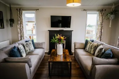 a living room with two couches and a coffee table at Ream Hills Holiday Park in Blackpool