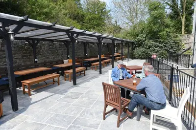 two men sitting at a table in a patio at The Royal Heysham in Heysham