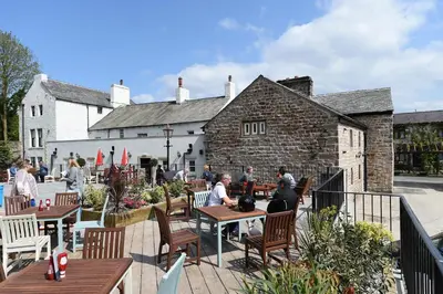 a group of people sitting at tables on a patio at The Royal Heysham in Heysham