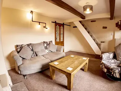 a living room with a couch and a coffee table at Tower View in Blackburn