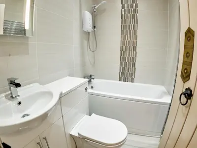 a bathroom with a toilet and a sink and a shower at Tower View in Blackburn