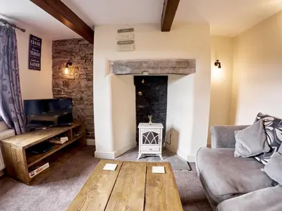 a living room with a couch and a fireplace at Tower View in Blackburn