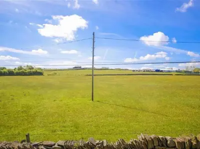 a telephone pole in a field of grass at Tower View in Blackburn