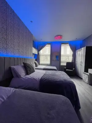a bedroom with two beds and a blue ceiling at 19 Rodney Street Apartments in Liverpool