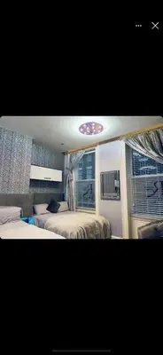 a bedroom with two beds and a window at 19 Rodney Street Apartments in Liverpool