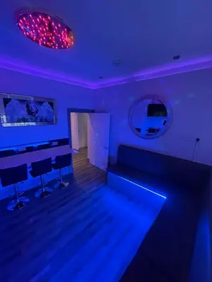a blue room with a couch and a mirror at 19 Rodney Street Apartments in Liverpool