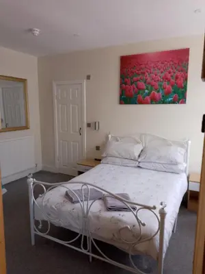 a bedroom with a bed with a painting on the wall at Meland (Families ONLY B&B) in Blackpool