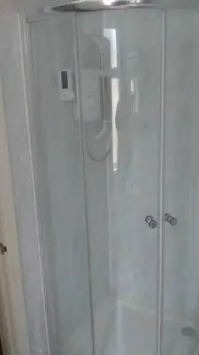 a shower with a glass door in a bathroom at Meland (Families ONLY B&B) in Blackpool