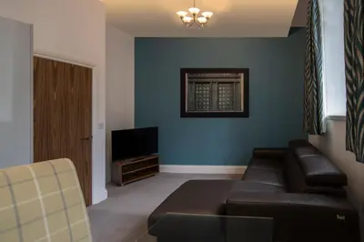 a living room with a couch and a television at The Castle Collection - 25 Castle Street in Liverpool