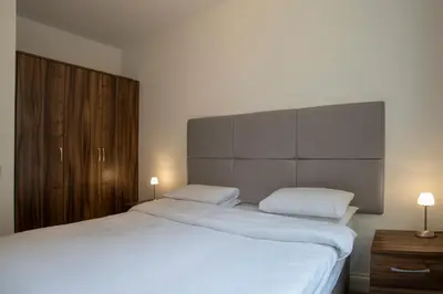 a bedroom with a large white bed and two lamps at The Castle Collection - 25 Castle Street in Liverpool