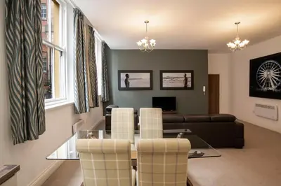 a living room with a glass table and chairs at The Castle Collection - 25 Castle Street in Liverpool