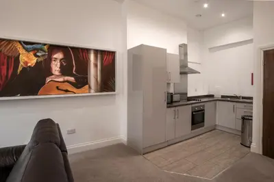 a kitchen with a couch and a painting on the wall at The Castle Collection - 25 Castle Street in Liverpool