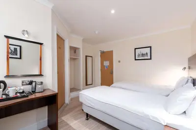 a hotel room with a bed and a telephone at Best Western Carlton Hotel in Blackpool