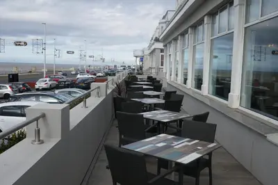 a row of tables on the balcony of a restaurant at Best Western Carlton Hotel in Blackpool