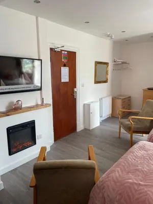 a room with a living room with a fireplace at San Remo Apartments Blackpool in Blackpool
