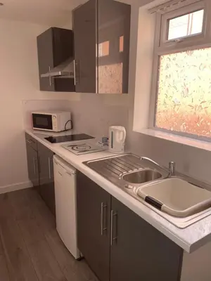 a small kitchen with a sink and a microwave at San Remo Apartments Blackpool in Blackpool