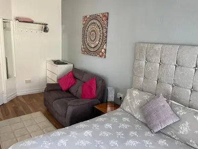 a living room with a couch and a chair at San Remo Apartments Blackpool in Blackpool