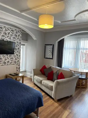 a living room with a couch and a table at San Remo Apartments Blackpool in Blackpool