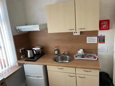 a small kitchen with a sink and a counter top at San Remo Apartments Blackpool in Blackpool