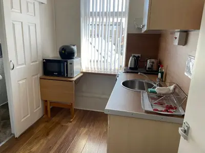 a small kitchen with a sink and a microwave at San Remo Apartments Blackpool in Blackpool
