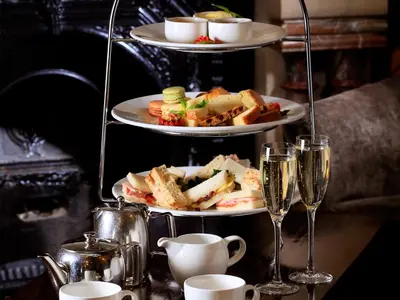 two plates of food on a table with glasses of wine at Macdonald Kilhey Court Hotel in Wigan