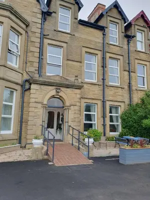 a large brick building with an entry way to it at Manhattan Lodge in Lytham St Annes