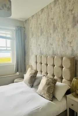 a bed with two pillows on it in a bedroom at The Commodore Inn in Grange Over Sands
