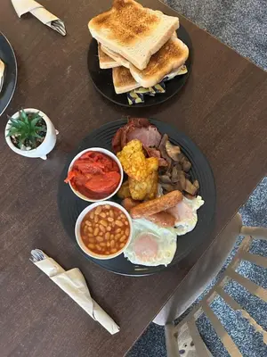 two plates of breakfast food on a wooden table at The Beckwood Hotel in Blackpool