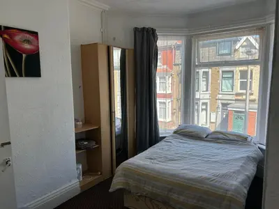 a bedroom with a bed and a window at The Beckwood Hotel in Blackpool