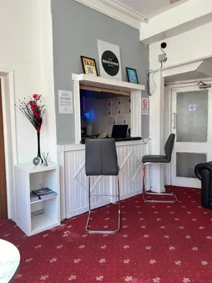 a hotel room with a desk and two chairs at The Beckwood Hotel in Blackpool
