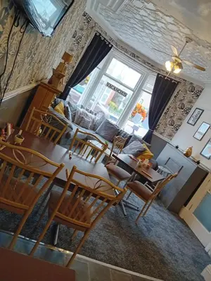 an aerial view of a living room with a table and chairs at The Beckwood Hotel in Blackpool