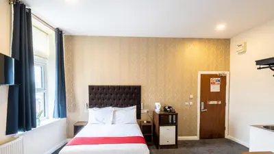 a hotel room with a bed and a window at Trivelles Seaforth in Bootle