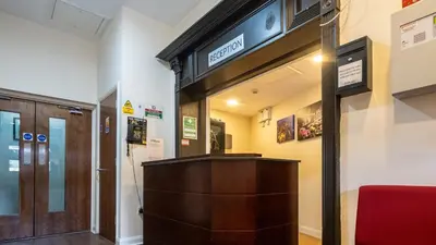 a entrance to a building with a sign on the wall at Trivelles Seaforth in Bootle