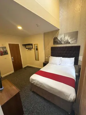 a bedroom with a large bed in a hotel room at Trivelles Seaforth in Bootle