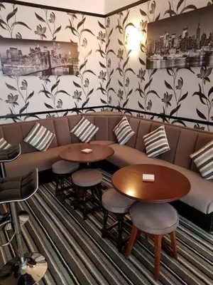 a restaurant with a couch and two tables and chairs at Montgomery Hotel in Blackpool