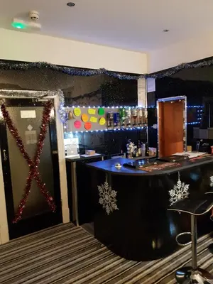 a bar in a restaurant with a christmas decoration at Montgomery Hotel in Blackpool