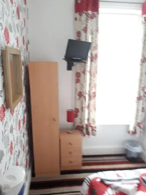 a bedroom with a bed and a window at Montgomery Hotel in Blackpool